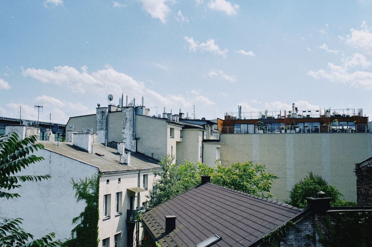 services-bg A picturesque view of Kraków's residential rooftops on a bright and sunny day.