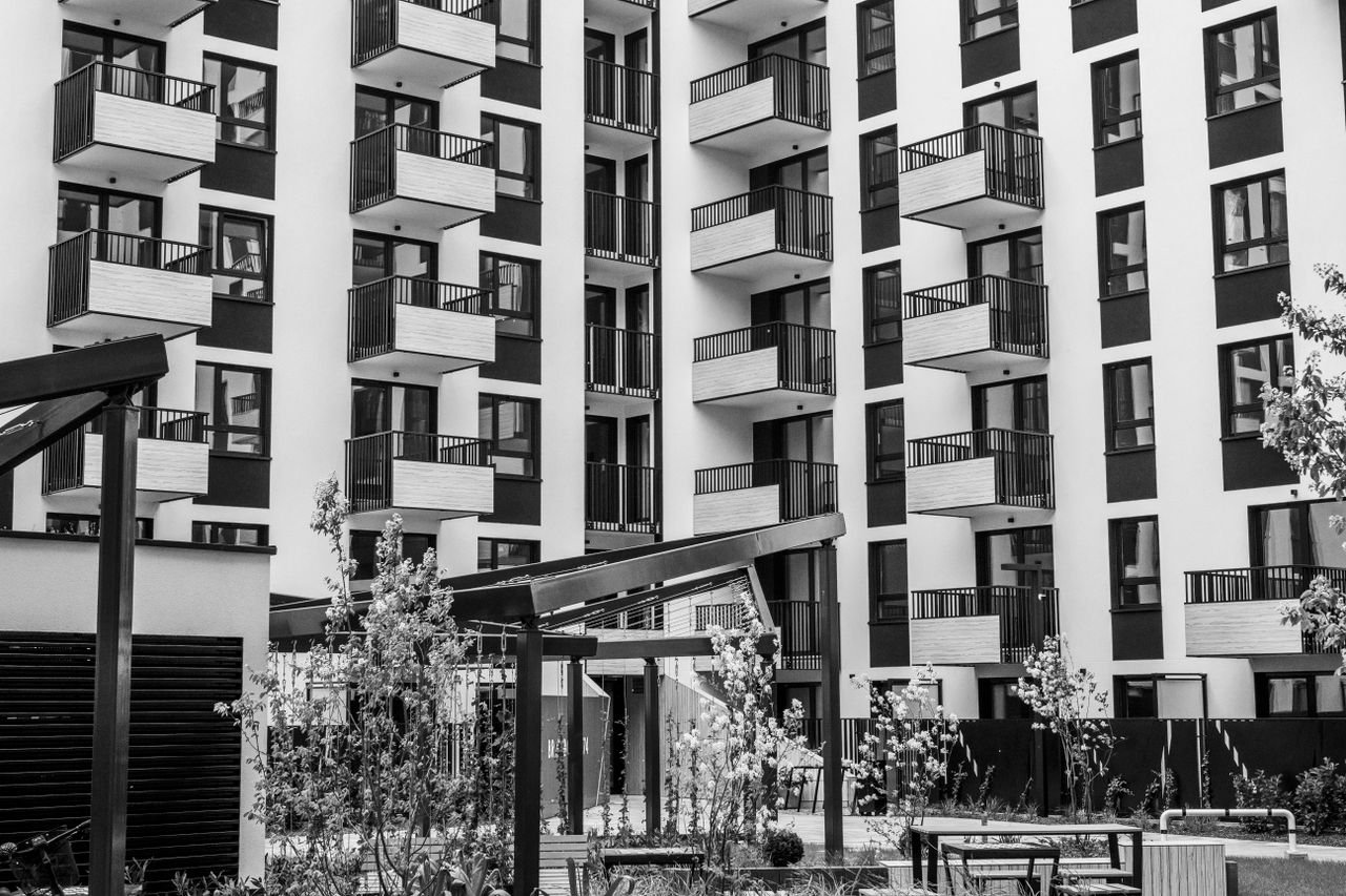 services-03 Contemporary urban apartment building with balconies and courtyard, black and white.